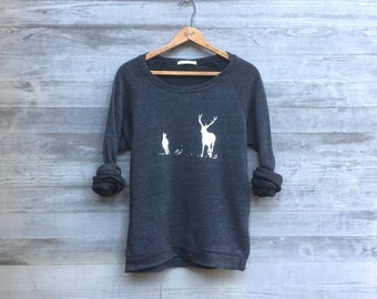 May include: A dark gray sweatshirt with a white graphic of a deer and a smaller animal standing in a field.