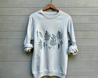 Sudadera unisex de algodón orgánico con estampado de helechos a mano