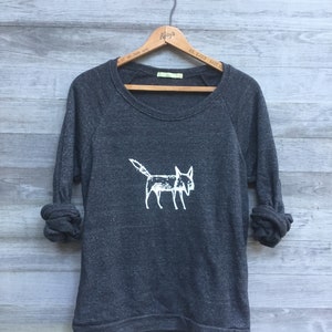 May include: A dark gray sweatshirt with a white graphic of a fox on the front. The sweatshirt has long sleeves and a crew neck.