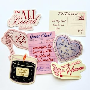 May include: A selection of stickers with romantic book club themes. Includes a postcard, guest check, heart-shaped sticker, and stickers with phrases like "I'm All Booked" and "match made in Heaven". The color scheme is mainly pink, cream, and black.