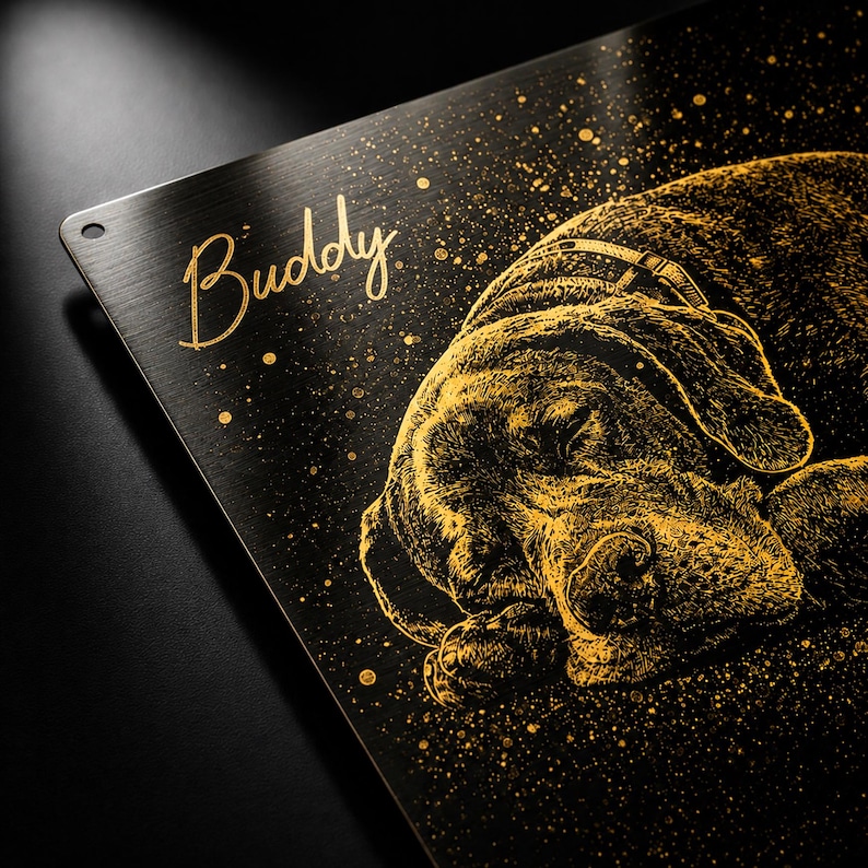 May include: A black metal sign featuring a gold illustration of a sleeping dog. The dog wears a collar. The name "Buddy" is written in gold script above the dog. Gold speckles are scattered across the sign.