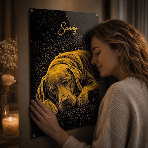 May include: A black and gold pet portrait of a sleeping dog, with the name "Sunny" in script. The artwork has a textured, glowing effect, creating a warm aesthetic. The portrait is displayed on a wall, with a person's arm and face visible.