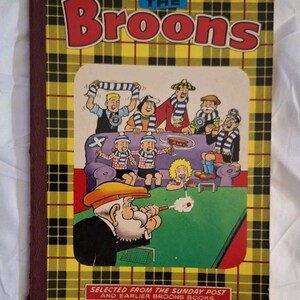 May include: A vintage copy of "The Broons" comic book. The cover is yellow and black plaid, with the title in red. The illustration shows a family scene. The text at the bottom reads "Selected from the Sunday Post and Earlier Broons Books."