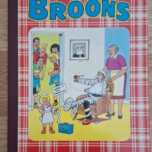 May include: A vintage copy of "The Broons" comic book, featuring a red and white checked cover. The cover illustration shows a hospital scene with cartoon characters. Text includes "Ward 7 Nae Smoking" and "Selected from the Sunday Post".