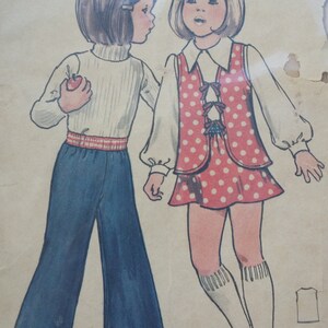 May include: A vintage sewing pattern for children's clothing. The pattern includes instructions for a red and white polka dot skirt and a blue pair of pants. The pattern is labeled "The Fashion One" and "Children's".