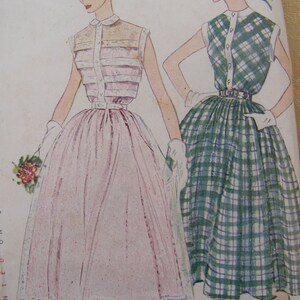 May include: Two women's dresses, one with a pink skirt and a white and pink striped top, the other with a green and white plaid skirt and a white and green plaid top.