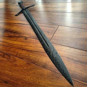May include: A long, dark sword with a patterned blade and a crossguard. The handle is wrapped in brown material, and the pommel is a darker shade. The blade has a unique, swirling pattern.