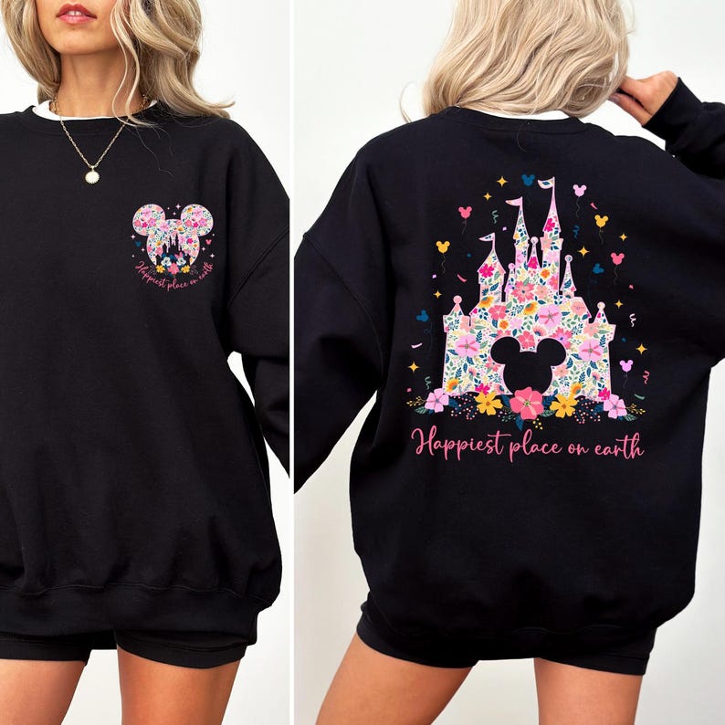 May include: Black sweatshirt with a white collar featuring a floral Mickey Mouse design on the front and back. The back design includes a castle and the words "Happiest place on earth".