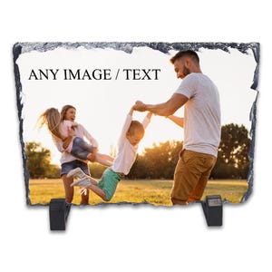 May include: A rectangular slate photo plaque with a family photo and the text "ANY IMAGE / TEXT". The plaque has a rough, textured edge and two black stands on the back.