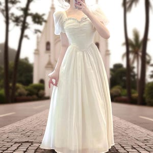 flowy dress for prenup Excited to unveil my design a simple nude tulle gown that's effortlessly flowy and feminine, perfect for a beach prenup photo shoot session. Can't wait to see this creation dance