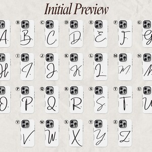 May include: White phone cases with a black cursive initial letter from A to Z. The image is labeled "Initial Preview". The cases have a camera cutout and buttons. The background is a light beige color.