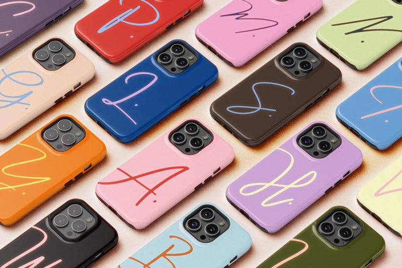 May include: A collection of colorful phone cases, each featuring a unique color and a handwritten-style initial. The cases are in various shades, including pink, blue, orange, and purple. The design is modern and stylish, suitable for personalizing a phone.