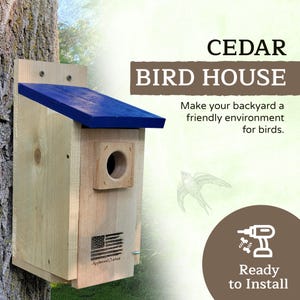 Puede incluir: Una casa para p&aacute;jaros de cedro con techo azul, montada en un &aacute;rbol. La casa para p&aacute;jaros tiene un agujero de entrada redondo y una peque&ntilde;a bandera americana. Texto: "CEDAR BIRD HOUSE" y "Ready to Install."