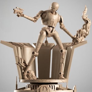 May include: A beige-colored K-2SO droid figure from the Star Wars franchise. The figure is posed on a detailed platform, holding a blaster in one hand and a stylized flame in the other. The figure is approximately 12 inches tall.