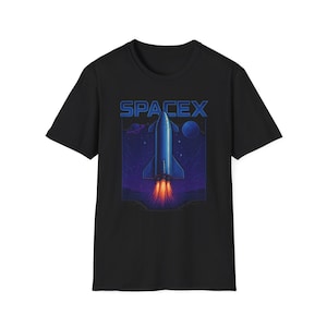 May include: Black t-shirt featuring a blue SpaceX rocket launching into space, with the SpaceX logo at the top. The rocket has orange flames and is set against a purple and blue starry background.