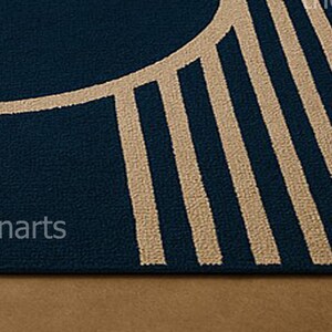 Close-up texture view of navy blue and ivory abstract area rug with clean lines