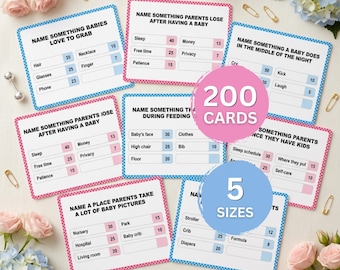 Pode incluir: Um conjunto de cartas de jogo para chá de bebê com perguntas estilo pesquisa e valores de pontos. As cartas têm bordas rosas ou azuis e incluem texto como Name Something Babies Love To Grab e Name Something Parents Lose.