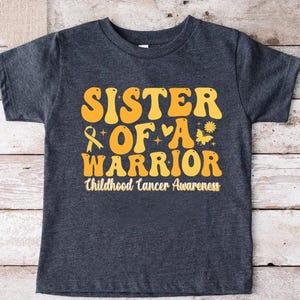 Sister Of a Warrior Childhood Cancer Awareness Shirt,Childhood Cancer Family Shirt,Pediatric Cancer Warrior Gift,Gold Ribbon Kids Cancer Tee