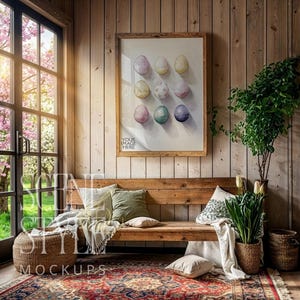 May include: A rustic interior scene featuring a wooden bench with pillows and a rug. A framed artwork of painted eggs hangs on the wooden wall. The text "YOUR IMAGE HERE" is visible on the artwork. A window with a view of a flowering tree is on the left.