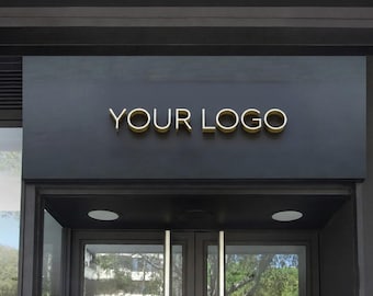 May include: A storefront sign with the text "YOUR LOGO" in gold lettering against a dark gray background. The sign is mounted above a glass door entrance.