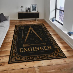May include: Black rectangular rug with a gold border and engineering-themed graphics. The rug features a compass, ruler, and the word "ENGINEER" in gold lettering. The rug is placed on a wooden floor.