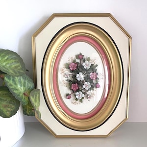 May include: A white ceramic mug with a black handle and the text "But First, Coffee" in a black, handwritten-style font. The mug is on a white surface.