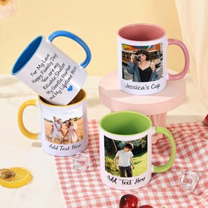 May include: Four white ceramic mugs with custom photos and text. Each mug has a different colored handle and interior: blue, pink, yellow, and green. One mug says "Jessica's Cup". Another says "For My Love Happy Family Day! You are my Reliable Shelter..."