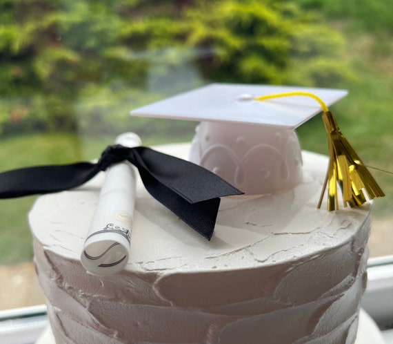White Graduation Cap And Diploma