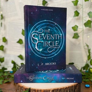 May include: Two hardcover books titled "The Seventh Circle" by L.P. Brooks. The books have a dark blue and purple cover with a circular design and the title in white. The books are displayed on a wooden slice.