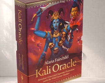 May include: A boxed set of the "Kali Oracle" by Alana Fairchild. The box is burgundy with gold accents and features an illustration of a blue deity with multiple arms, holding a sword. The text on the box reads "Ferocious Grace and Supreme Protection with the Wild Divine Mother."