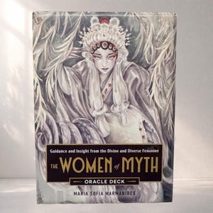 May include: An oracle deck titled "The Women of Myth" with a watercolour illustration on the cover. The image shows a woman in a white headdress and robe. The text reads "Guidance and Insight from the Divine and Diverse Feminine."