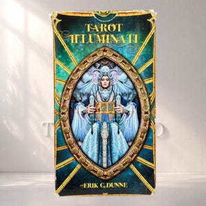 May include: A rectangular Tarot Illuminati deck box featuring a central oval frame with a figure in blue and white robes holding an open book. The background is a deep teal with gold geometric lines. The text reads Tarot Illuminati and Erik C. Dunne.