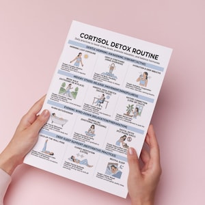 May include: A white paper with the title "CORTISOL DETOX ROUTINE" and illustrations of daily practices for relaxation and hormone balance. The paper is held by hands against a pink background. The text includes "Morning Light Exposure" and "Gentle Stretching."