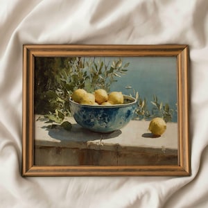 May include: A framed painting depicts a still life of lemons in a blue and white bowl. The bowl sits on a stone ledge with a coastal background. The painting has a warm, vintage aesthetic.