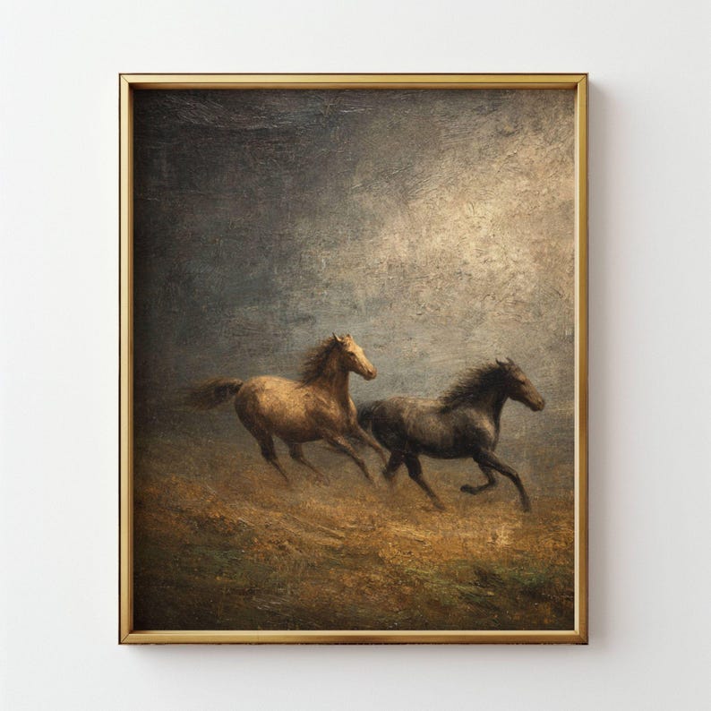 Op de afbeelding: Een ingelijst schilderij toont twee paarden die over een veld galopperen. E&eacute;n paard is bruin, de ander is donkergrijs. Het kunstwerk heeft een vintage esthetiek met een gouden lijst en een bewolkte lucht.