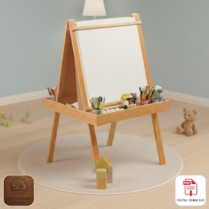 May include: A wooden children's art easel with a white drawing surface. The easel has a lower shelf with art supplies, including pencils and markers. A small teddy bear and building blocks are nearby.