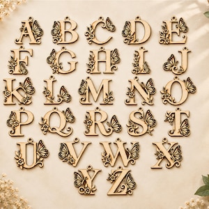 May include: A complete set of twenty-six wooden alphabet letters from A to Z, each featuring a laser-cut design of a butterfly and small flowers attached to the side. Every letter includes a small circular loop at the top for hanging purposes.