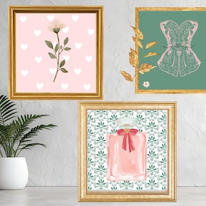 May include: Three framed art prints. One features a pink background with white hearts and a floral illustration. Another showcases a green background with a pink corset design. The third print displays a pink perfume bottle with a red bow on a patterned background. All are in gold frames.