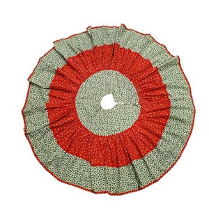 May include: A circular tree skirt featuring a central panel of light green fabric with a small dark green floral pattern, surrounded by a wide, pleated red band with a white floral print, finished with a red scalloped edge trim.