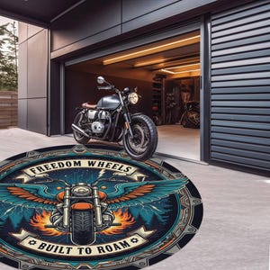 May include: A round rug with a motorcycle graphic and the text "FREEDOM WHEELS BUILT TO ROAM". The rug features a motorcycle with wings, set against a forest and lightning background. A motorcycle is parked nearby.