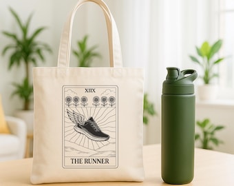 May include: A cream-colored tote bag with a black and white graphic of a running shoe with wings, labeled "THE RUNNER." Next to it is a green water bottle. The bag has a rectangular design with a handle. The water bottle is cylindrical with a flip-top lid.
