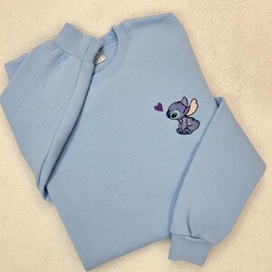 Stitch Embroidered Sweatshirt - Cute Disney Crewneck - Trip And Vacation Shirt - Trendy Tee stitch sweatshirt stitch crewneck stitch embroidered lilo and stitch stich angel disney embroidered stitch sweater embroidered disney stitch valentines stitch pullover valentine day cute adorable embroidered shirt