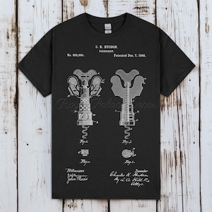 May include: Black t-shirt featuring a white diagram of a corkscrew, with detailed illustrations and text. The text includes "C. H. Hudson. Corkscrew. Patented Dec. 7, 1886." and "No. 353,860."