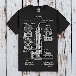 May include: Black t-shirt featuring a detailed white diagram of an alcohol still, including various components and labels. The text includes "A. Dieryckx Alcohol Still" and "Patented June 8, 1880."