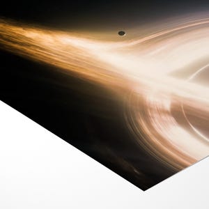 May include: An artistic depiction of a black hole, featuring swirling light and dark colors. The image showcases a celestial body with a bright, glowing ring and a dark center, with a small planet in the background.
