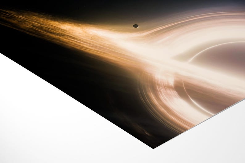May include: An artistic depiction of a black hole, featuring swirling light and dark colors. The image showcases a celestial body with a bright, glowing ring and a dark center, with a small planet in the background.
