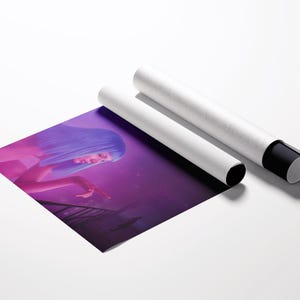 May include: A rolled art print featuring a woman with blue hair in a purple and pink setting, next to two white cylindrical tubes with black end caps. The print is partially unrolled, revealing the artwork.