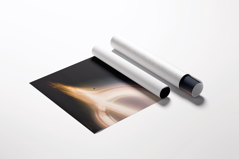 May include: A black and gold art print depicting a black hole, partially rolled, with two white cylindrical tubes. The tubes have black and gray end caps. The print is on a white surface.