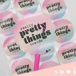May include: A sheet of iridescent pink, blue, and white round stickers with the text "really pretty things inside" in black.