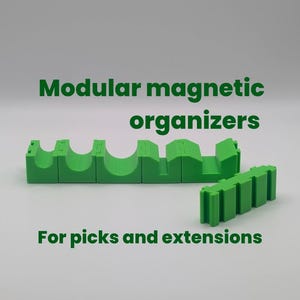 May include: Green modular magnetic organizers for picks and extensions. The image shows two green plastic organizers. The text on the image says "Modular magnetic organizers" and "For picks and extensions."